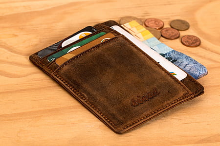 brown leather wallet with banknotes and coin thumbnail