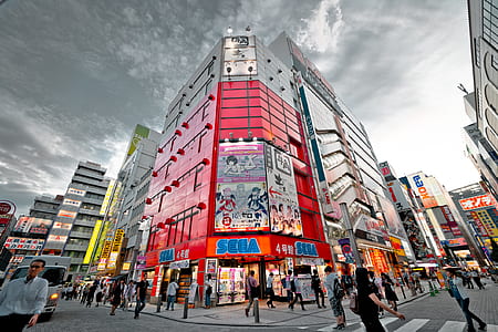 photography of group of people walking front Sega building thumbnail