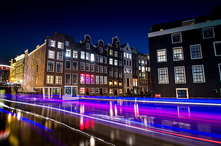 long exposure photography of road with buildings during nighttime thumbnail
