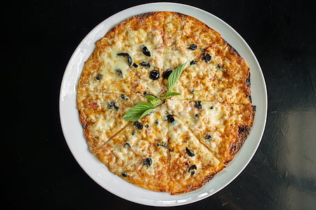 cheesy pizza on round white plate thumbnail