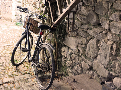 black city bike near grey stone wall thumbnail