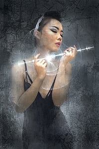 woman wearing black tank top and holding light graphic illustration thumbnail