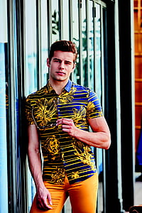 man wearing floral button-up shirt leaning on glass door thumbnail