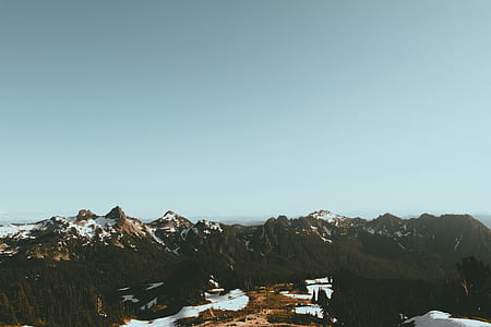 aerial photography of snow-covered mountains under blue sky thumbnail