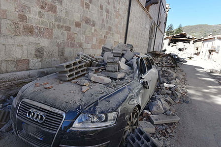 blue Audi car with concrete hollow blocks of hood thumbnail