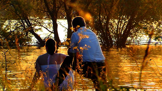 couple facing river during golden hour thumbnail
