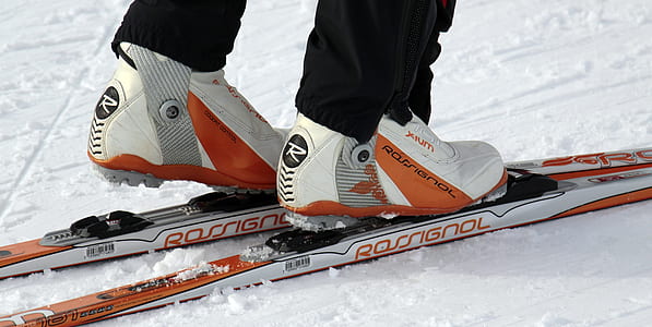 person on white and orange Rossignol snow skis photo thumbnail