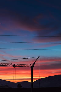 silhouette of metal post photo during golden hour thumbnail