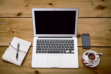 silver Macbook Air near note book and coffee thumbnail