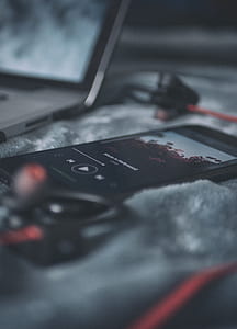 black phone beside laptop thumbnail