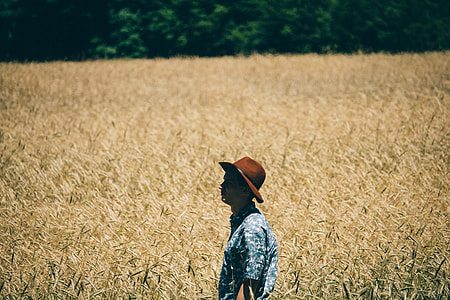 man standing at the brown field thumbnail