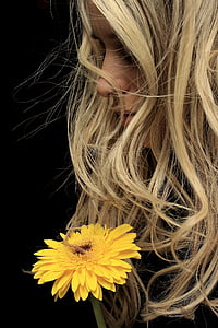 woman holding yellow flower thumbnail