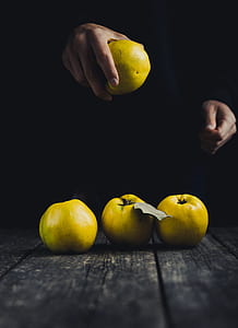 person holding yellow fruit thumbnail