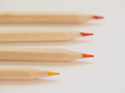 Tilt Shift Lens Photography of Orange Coloring Tool thumbnail