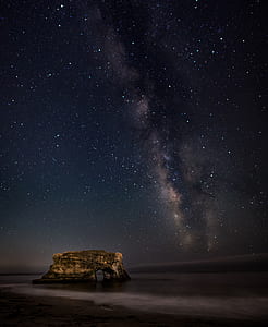 rock monolith during nighttime with shining stars thumbnail