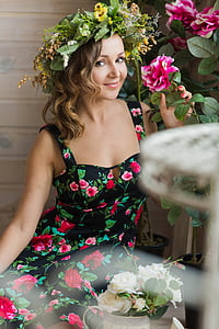 woman holding pink flower with flower headdress thumbnail
