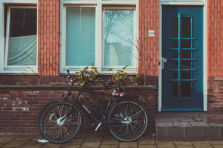 two black road bikes beside window thumbnail