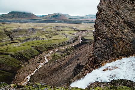 Glacier water winding through rocky landscape of a mountain in Iceland thumbnail