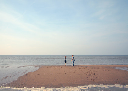 two person standing on front of ocean thumbnail