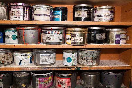 assorted grey-metallic cans on brown wooden rack thumbnail