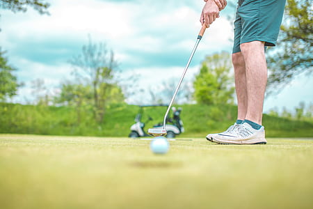 selective focus of man playing golf during daytime thumbnail