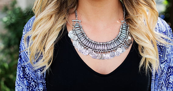 woman wearing silver-colored bib necklace thumbnail
