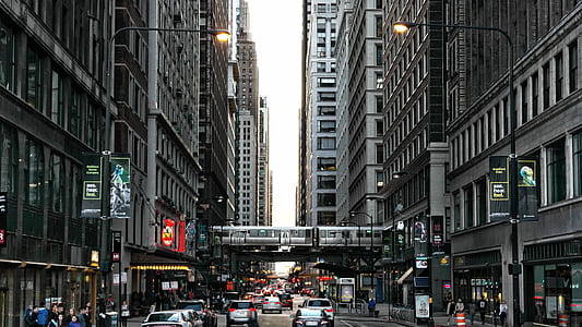 cars on road between buildings thumbnail