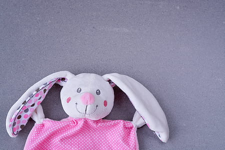 white and pink rabbit plush toy on gray surface thumbnail