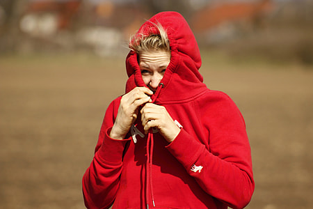 woman in red hoodie covering her face with the hood thumbnail