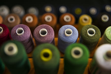 Selective Focus Photography Of Assorted Coloured Thread Spools thumbnail