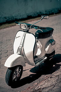 white Vesta moped park on street during daytime thumbnail