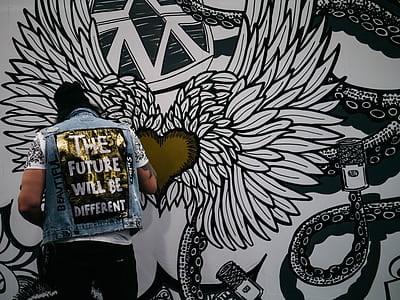 man painting heart with hearts on wall thumbnail