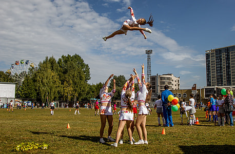cheerleader tossed upwards outdoors thumbnail