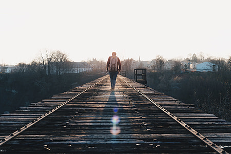 man walking through train rail thumbnail