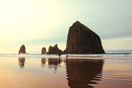 two person's walking on body of water thumbnail