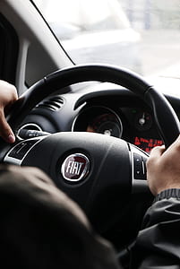 person driving FIAT vehicle during daytime thumbnail