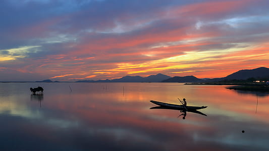 black boat on body of water thumbnail