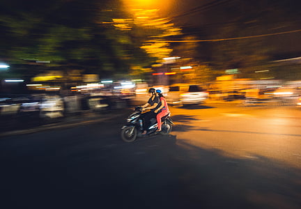 timelapse photography two person riding on motorcycle during nighttime thumbnail