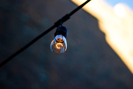 light bulb hanging on black cable thumbnail