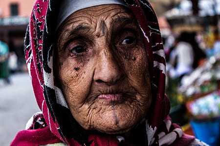 woman wearing maroon and white floral headdress thumbnail