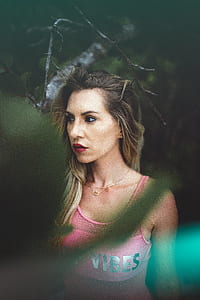 woman wearing red lipstick and pink sleeveless top thumbnail