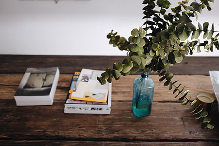 blue glass bottle on wooden table thumbnail