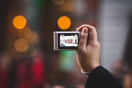 person holding digital camera thumbnail