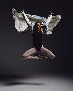 woman in black leotard jump shot photo thumbnail