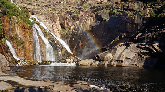 waterfall with rainbow at daytime thumbnail