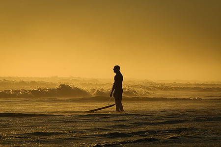 silhouette of man standing on seashore thumbnail
