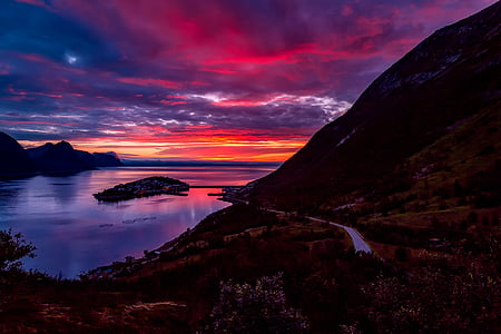 brown mountain under the cloudy sky during sunset thumbnail