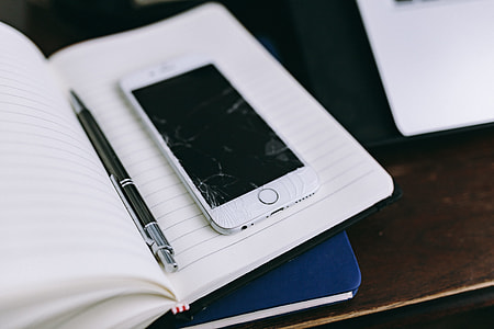 Elegant workspace with Macbook, iPhone, business cards and notebooks thumbnail