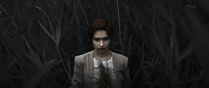 selective color photography of woman surrounded by plants thumbnail