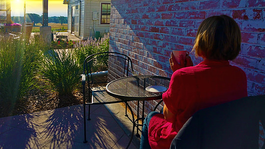woman wearing red top and blue pants holding white ceramic mug thumbnail